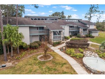 Exterior of a condo building, showing landscaping, walkways, and a small fountain at 2070/2071 Corner Lake Dr # 2, Haines City, FL 33844