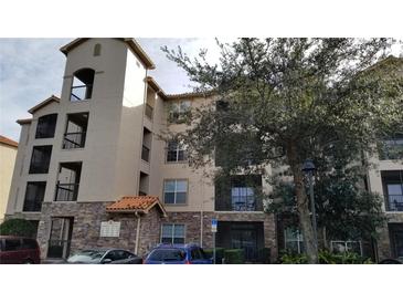 Three-story building exterior with balconies and parking at 8010 Tuscany Way # 5308, Davenport, FL 33896