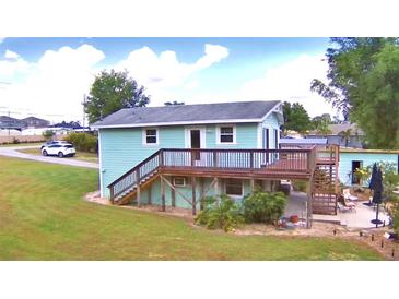 Aerial view of a charming light blue house with a deck at 4920 Old Lucerne Park Ne Rd, Winter Haven, FL 33881
