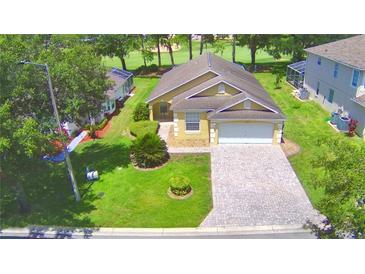 House with driveway and landscaped yard at 1608 Forest Hills Ln, Haines City, FL 33844