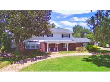 Two-story house with brick and white siding, large yard at 1950 El Paso Trl, Bartow, FL 33830