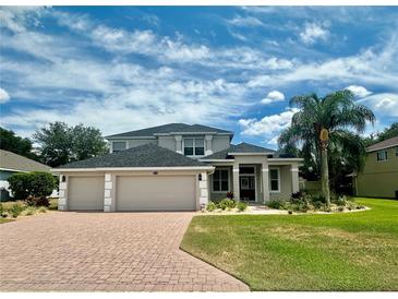 Two-story home with a large driveway and manicured lawn at 1876 Eloise Cove Dr, Winter Haven, FL 33884