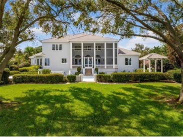 Luxury home with screened porch, gazebo, and lush lawn at 108 Campbell Dr, Winter Haven, FL 33884