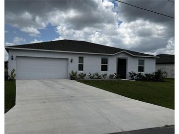 Newly built home with a two-car garage and well-maintained lawn at 177 Cimarron Ln, Kissimmee, FL 34759