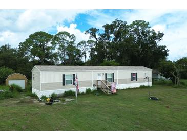 Single-wide manufactured home with a large backyard at 1815 Christy Ln, Lakeland, FL 33801