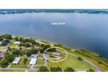 Aerial view of a home nestled on the shores of Lake Clinch at 405 W 4Th Ct, Frostproof, FL 33843