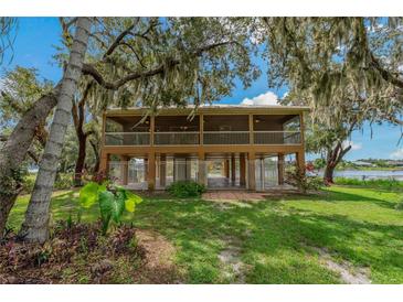 Elevated home with screened porch overlooking the lake at 3038 Spirit Lake Dr, Winter Haven, FL 33880