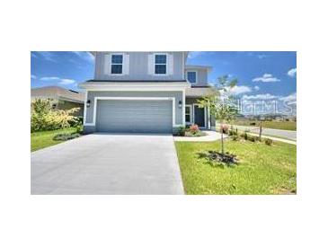 Two-story house with a gray exterior and attached garage at 1480 Leamington Lane, Winter Haven, FL 33884