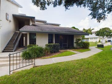 Ground level condo entrance with stairs and landscaping at 2049 San Marcos Se Dr # 127, Winter Haven, FL 33880