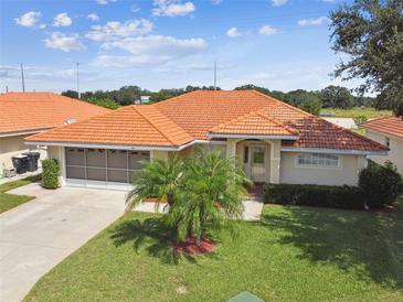 One-story house with a terracotta tile roof and lush landscaping at 142 Morning Glory Cir, Winter Haven, FL 33884