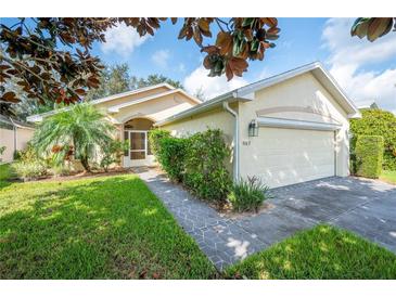 Single story home with two car garage and landscaped yard at 4189 Cannes Ave, Lake Wales, FL 33859