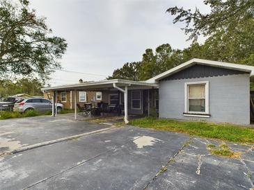 Front view of a house with a carport, and a small front yard at 3511 Avenue R Nw, Winter Haven, FL 33881