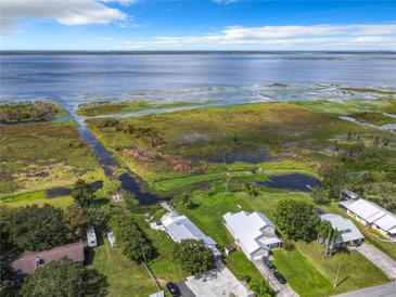 Aerial view of waterfront home with private dock and expansive lake views at 3198 Tohopekaliga Dr, Saint Cloud, FL 34772