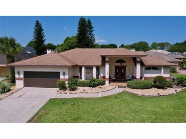 Single-story home with a two-car garage and manicured lawn at 209 Santa Rosa Dr, Winter Haven, FL 33884