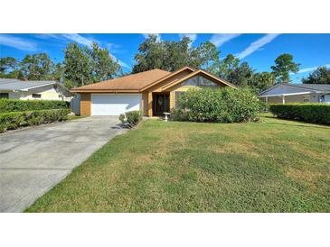 Single-story house with attached garage and well-manicured lawn at 222 Okaloosa Dr, Winter Haven, FL 33884