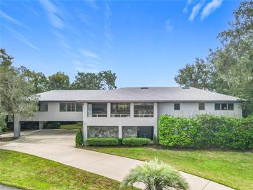 Single-story home with a large driveway and landscaped lawn at 18 Coventry Dr, Haines City, FL 33844