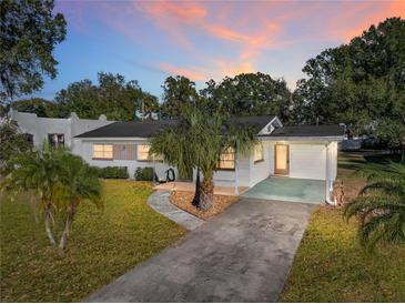 Charming single story home with a carport and palm trees in the front yard at 422 21St Sw St, Winter Haven, FL 33880