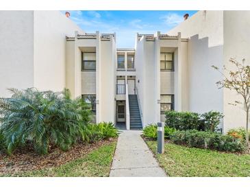 Condo building exterior with walkway and landscaping at 603 Sweet Bay Cir # 603, Winter Haven, FL 33884