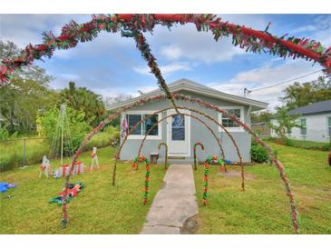 Cute festive home exterior, nicely landscaped lawn, inviting walkway at 841 4Th St, Winter Haven, FL 33881