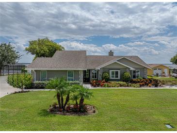 Single-story home with landscaped yard and gray exterior at 328 Sunshine Dr, Lake Wales, FL 33859