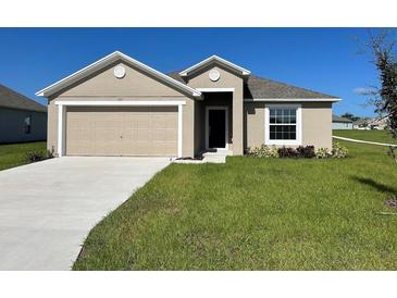 One-story home with a two-car garage and well-maintained lawn at 1061 Bergamot Dr, Bartow, FL 33830