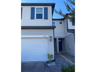Two-story townhome with attached garage and paver driveway at 15121 Willow Arbor Cir, Orlando, FL 32824