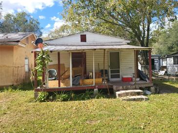 Small house with porch and yard, needs renovation at 6936 Wilson Ave, Mulberry, FL 33860