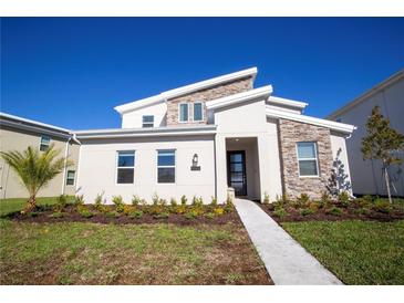 Modern two story home with stone accents and landscaping at 4577 Target Blvd, Kissimmee, FL 34746