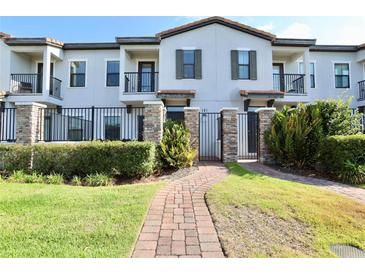 Townhouse with private gated entrance and landscaped walkway at 121 Kenny Blvd, Haines City, FL 33844