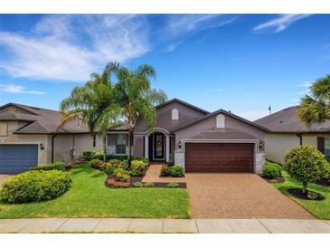 Single-Gathering home with landscaped yard and brick driveway at 668 Cordoba Dr, Davenport, FL 33837