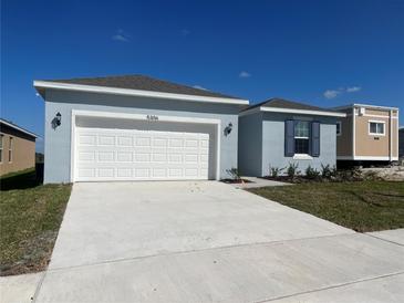 Light blue house with white garage door at 5306 Maddie Dr, Haines City, FL 33844