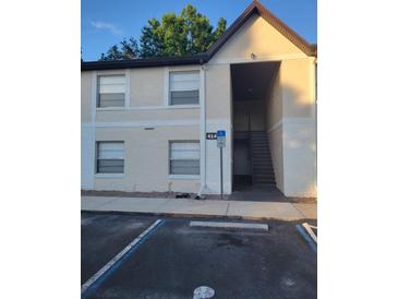 Exterior view of a two-story building with stairs and parking in front at 414 Banana Cay Dr # I, South Daytona, FL 32119