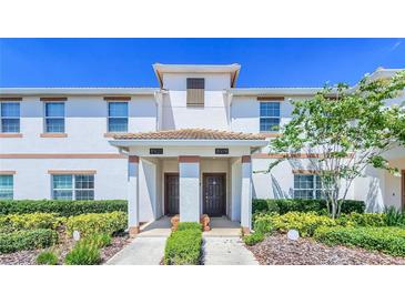 Front view of two-story townhome with landscaping at 8919 Stinger Dr, Davenport, FL 33896