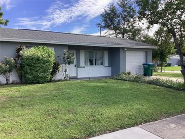 Ranch style home with well-manicured lawn and attached garage at 101 Albert St, Winter Springs, FL 32708