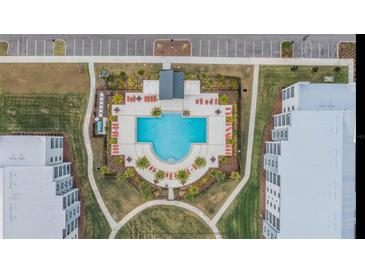Resort-style pool with plenty of lounge chairs and a covered seating area at 3191 Paradox Cir # 205, Kissimmee, FL 34746