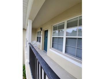 Private balcony with teal door and seating at 714 Siena Palm Dr # 203, Celebration, FL 34747