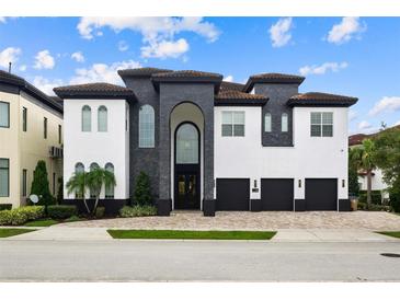Luxury home with stone and white exterior at 1125 Grand Traverse Pkwy, Reunion, FL 34747