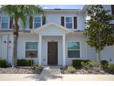 Two-story home with brown door and landscaping at 3208 Cupid Pl, Kissimmee, FL 34747