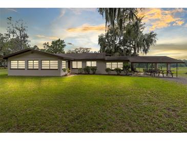 Single story home with covered patio and large yard at 950 S Narcoossee Rd, St Cloud, FL 34771