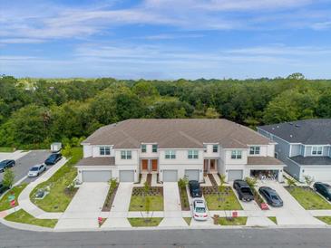 Aerial view of townhomes with garages at 4801 Sparkling Shell Ave, Kissimmee, FL 34746