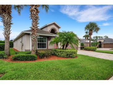 Well-maintained lawn, landscaping, and paved driveway at 500 Playa Dr, Davenport, FL 33837