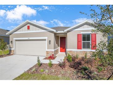 New construction home with red shutters and stone accents at 2043 Stetson Ct, Eagle Lake, FL 33839