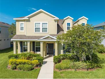 Two story house with landscaping and walkway at 2662 Trafalgar Blvd, Kissimmee, FL 34758
