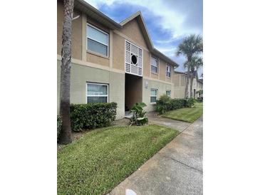 Attractive condo building with well-maintained landscaping at 9817 Turf Way # 8, Orlando, FL 32837
