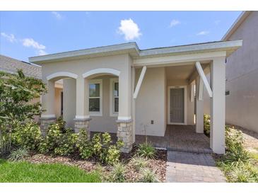 Exterior of charming one-story home with landscaped yard at 15424 Enchanted Melody Way, Winter Garden, FL 34787