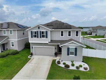 Two-story house with solar panels and landscaped yard at 592 Lake Smart Blvd, Winter Haven, FL 33881