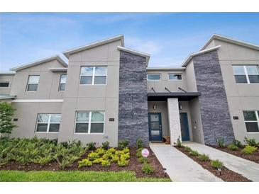Modern three-unit building with stone accents at 880 Pebble Beach Dr, Davenport, FL 33896
