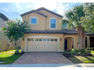 Two-story house with a two-car garage and landscaped front yard at 1921 Nice Ct, Kissimmee, FL 34747