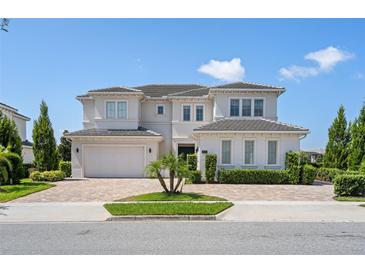 Two-story house with a three car garage and landscaping at 15620 Panther Lake Dr, Winter Garden, FL 34787