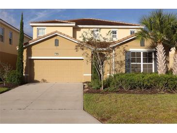 Two-story house with attached garage and landscaping at 5265 Oakbourne Ave, Davenport, FL 33837